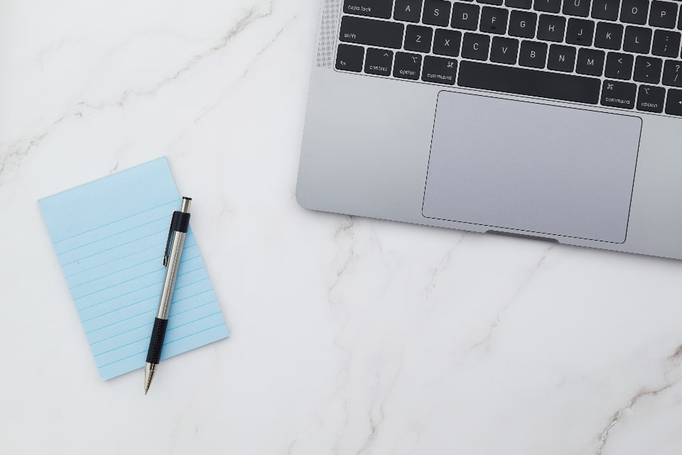 Minimalist desk workspace with a laptop keyboard visible in the corner
