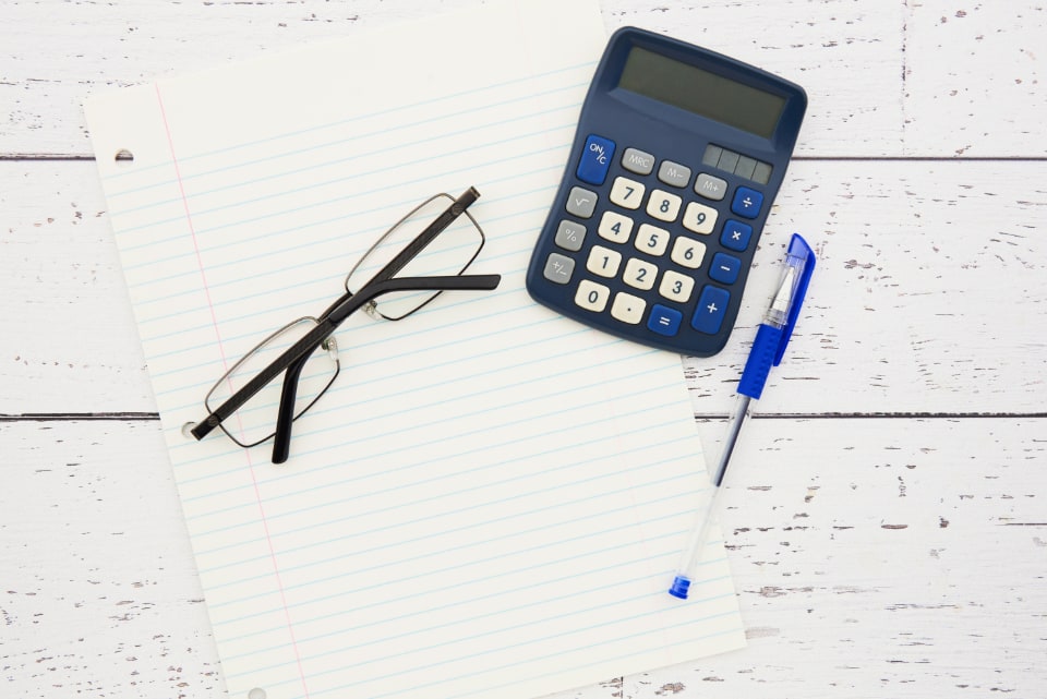 Minimalist desk with a calculator and paperwork